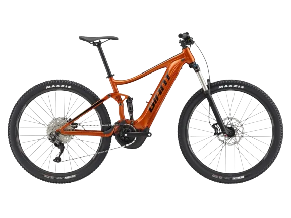 A stance e+ 1 electric bike in amber glow color, with a brand logo sticker named giant on the frame and maxxis tires.