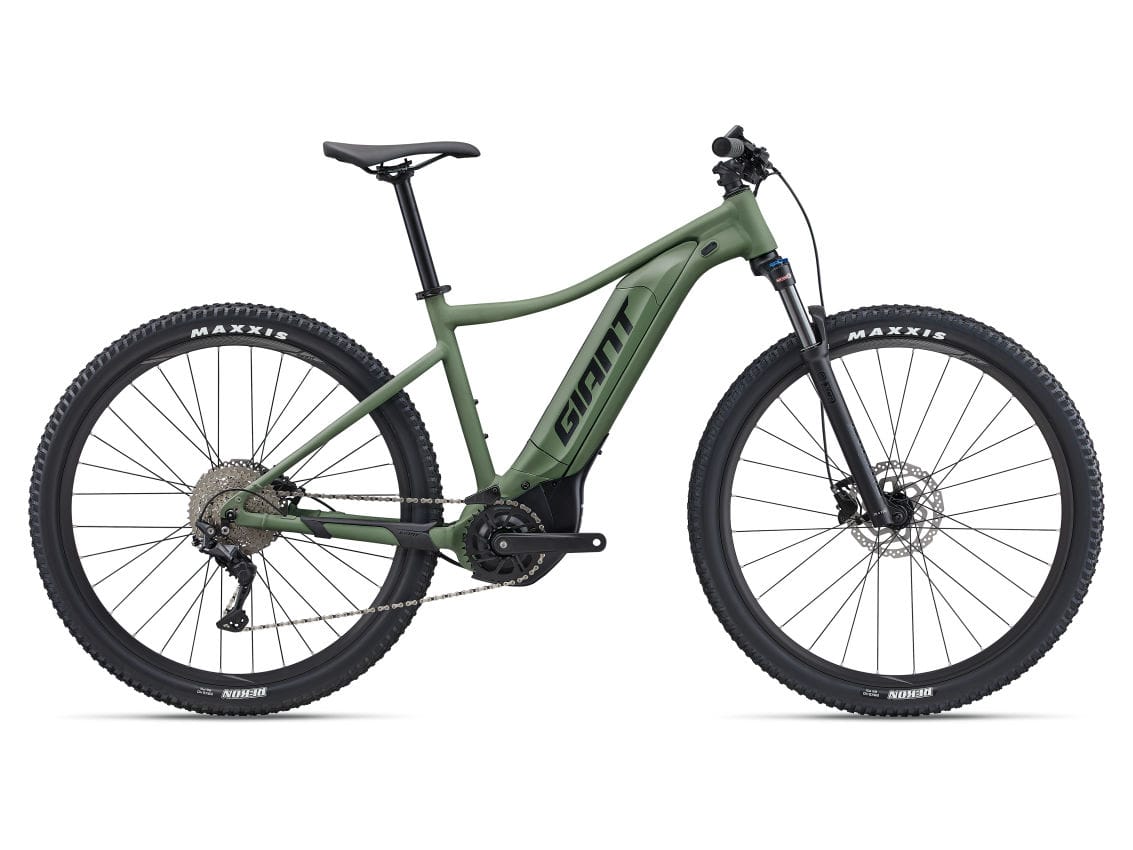 A talon e+ 29 2 electric mountain bikes in shale green color, with a brand sticker named giant on the frame and maxxis tires.