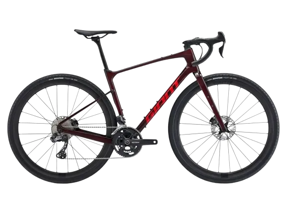 A giant revolt advanced pro 0 2023 bike in red color with the brand name logo giant on the frame.